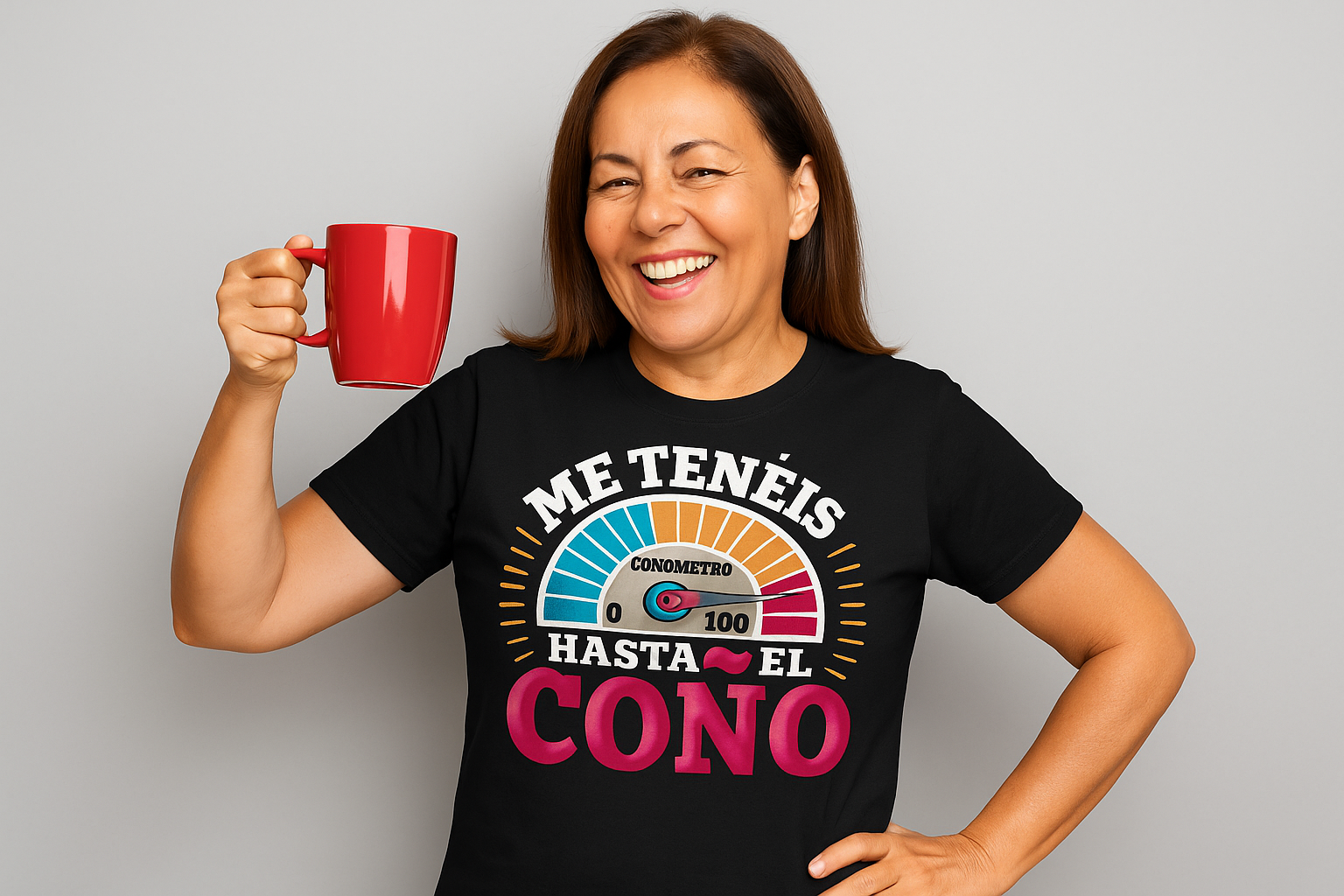 Mujer de 45 años sonriente con camiseta negra estampada con diseño humorístico, brindando con una taza roja sobre fondo gris.